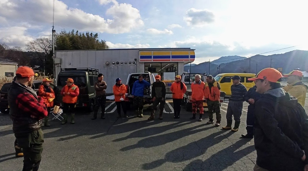 A hunting team gathers for a meeting before heading into the field